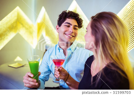 Happy couple enjoying cocktail in nightclub 31599703