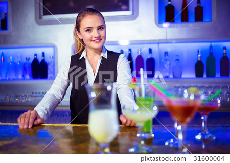 Portrait of smiling barmaid standing 31600004