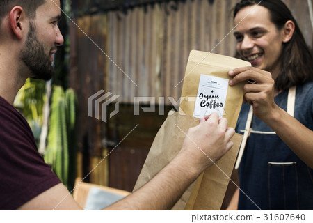 Man Selling Coffee Fresh Brew to People at Market Man Selling Coffee Fresh Brew to People at Market 31607640