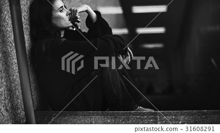 Adult Woman Sitting Look Worried on The Stairway Adult Woman Sitting Look Worried on The Stairway 31608291