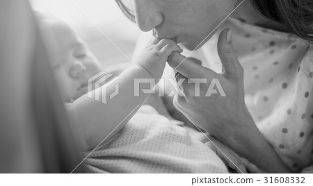 Mother is taking care of her baby. 31608332