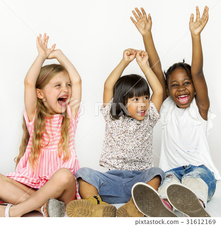 Diverse group of children sitting on the floor hands up Diverse group of children sitting on the floor hands up 31612169