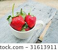strawberries in a cup on the wooden table 31613911