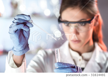 Young scientist pipetting in life science 31614491