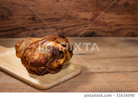 fried pork leg cooked on wood background fried pork leg cooked on wood background 31616090