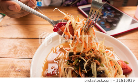 Close up of women eating spicy papaya salad Close up of women eating spicy papaya salad 31616939