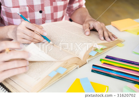 Young woman and man studying for a test/ an exam. Young woman and man studying for a test/ an exam. 31620702