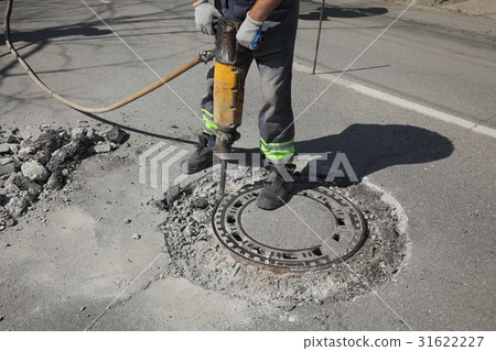 Asphalt demolishing, worker and jackhammer 31622227