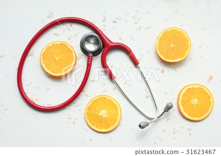 Stethoscope with fresh orange slices. Stethoscope with fresh orange slices. 31623467
