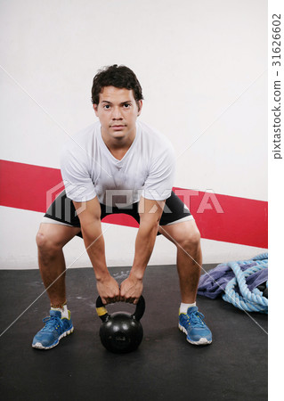 Young man Lifting Crossfit Kettle Bell Young man Lifting Crossfit Kettle Bell 31626602