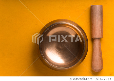 Tibetan singing bowl on the yellow background 31627243