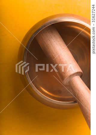 Tibetan singing bowl on the yellow background 31627244