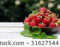 Ripe red strawberries on wooden table 31627544