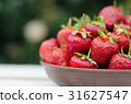 Ripe red strawberries on wooden table 31627547