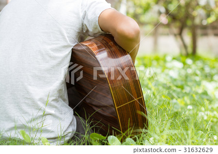 Happy young guitarist living On the lawn home. Happy young guitarist living On the lawn home. 31632629