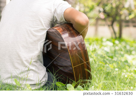 Happy young guitarist living On the lawn home. Happy young guitarist living On the lawn home. 31632630