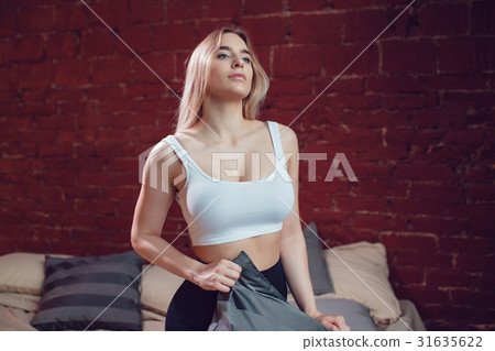 Sexy blonde woman with huge breast in a white tank Sexy blonde woman with huge breast in a white tank 31635622