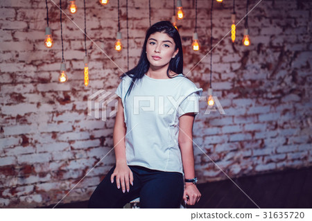 Attractive brunette woman in a white t-shirt Attractive brunette woman in a white t-shirt 31635720