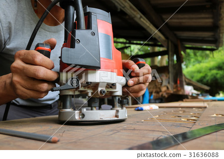 Electric routering to cut down stripes on the wood 31636088