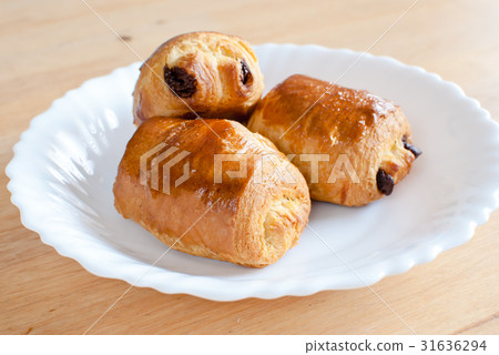Three bread aochocolas on white dishes Three bread aochocolas on white dishes 31636294