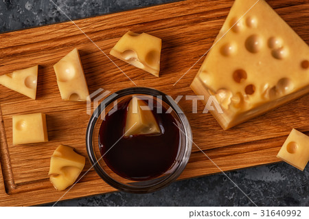 Cheese on cutting board. 31640992