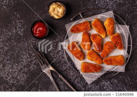 Chicken nuggets with sauces on dark background. 31640996