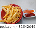 Fries potatoes with tomato and chili sauce. 31642049