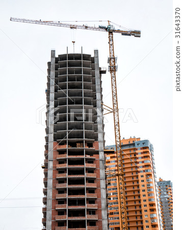 Crane near construction building. 31643370