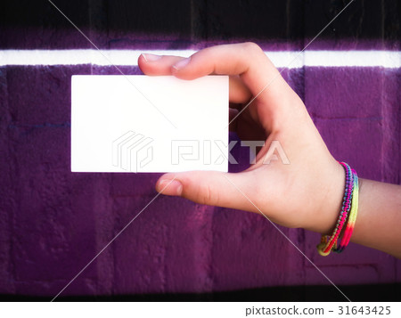 Female hand holding blank white business card. 31643425