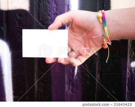 Female hand holding blank white business card. 31643428