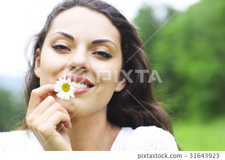 Happy pretty brunette woman in chamomile field Happy pretty brunette woman in chamomile field 31643923