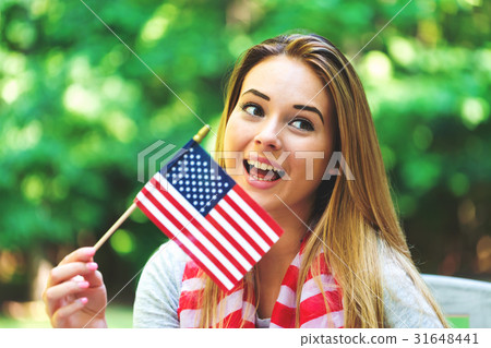 GIrl with an American flag on the fourth of July GIrl with an American flag on the fourth of July 31648441