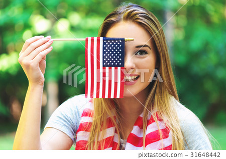 GIrl with an American flag on the fourth of July GIrl with an American flag on the fourth of July 31648442