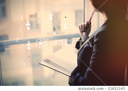 young beautiful woman holding a notebook and thinking near the w young beautiful woman holding a notebook and thinking near the w 31652145