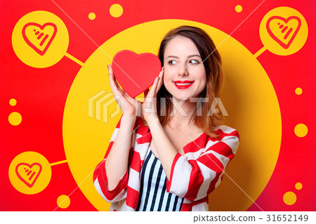 Woman with heart shape box on yellow background 31652149