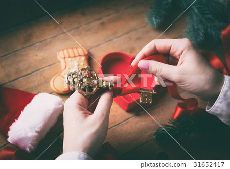 hands wrapping christmas golden key and gifts hands wrapping christmas golden key and gifts 31652417