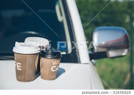 3 Cups of coffee on car hood 3 Cups of coffee on car hood 31656920