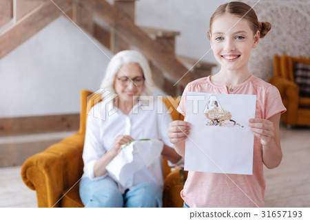 Cute happy girl showing you her embroidery Cute happy girl showing you her embroidery 31657193