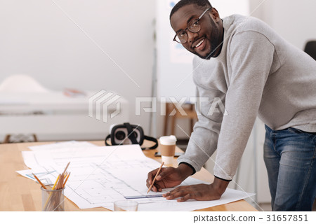 Positive handsome man leaning over the table Positive handsome man leaning over the table 31657851