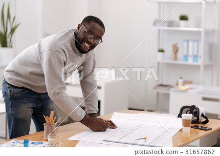 Cheerful positive engineer designing a building Cheerful positive engineer designing a building 31657867