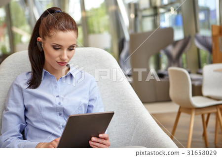 Successful business woman with a tablet computer 31658029