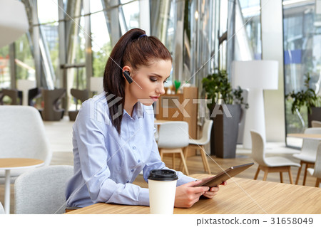 business woman sitting with touch pad 31658049