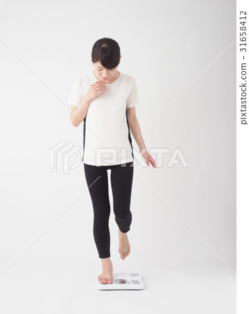 A fearful woman on a scale A fearful woman on a scale 31658412
