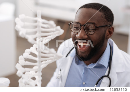 Smart modern scientist looking at the gene model Smart modern scientist looking at the gene model 31658530