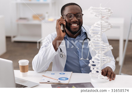 Joyful nice man speaking with his colleague on the 31658574