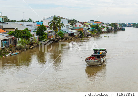 Wooden cargo boat on the Mekong River Delta Wooden cargo boat on the Mekong River Delta 31658881