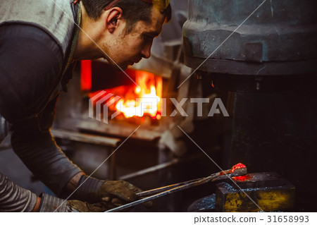 blacksmith working in the forge 31658993