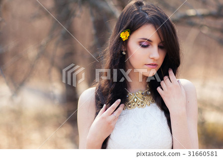 Young beautiful woman with flowers in hair 31660581