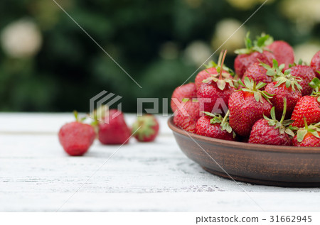 Strawberries ripe red on wooden table 31662945