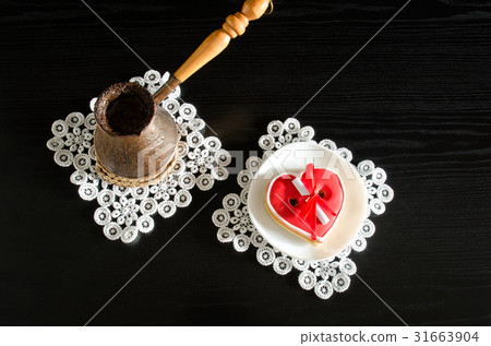 Jezva with coffee, saucer with red gingerbread Jezva with coffee, saucer with red gingerbread 31663904
